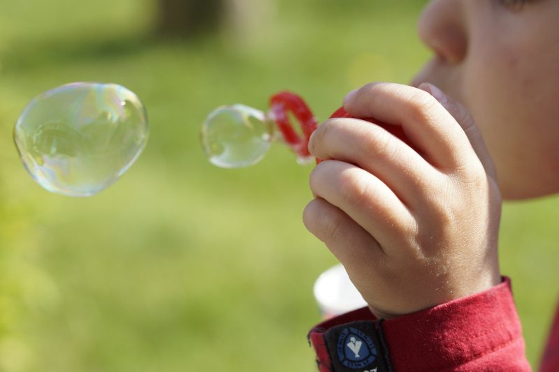toddler blowing bubbles